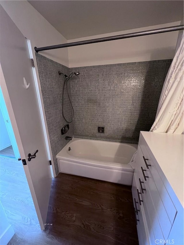 full bathroom with shower / washtub combination and wood finished floors