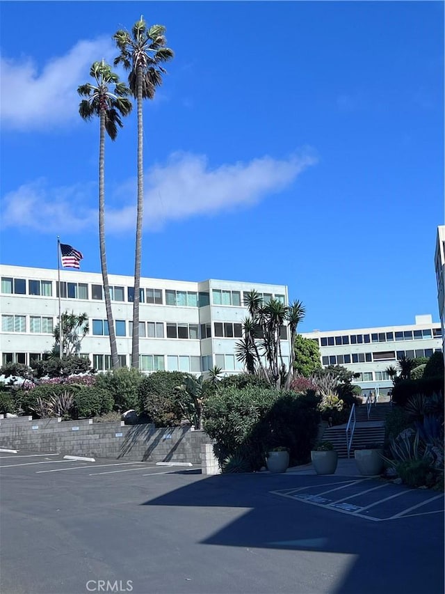 view of building exterior with uncovered parking