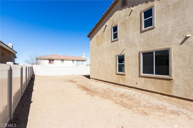 12990 Campbell Ct, Hesperia, CA 92344 - view of side of home with a fenced backyard and stucco siding