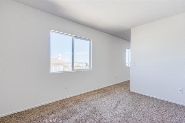 12990 Campbell Ct, Hesperia, CA 92344 - carpeted empty room featuring a healthy amount of sunlight and baseboards