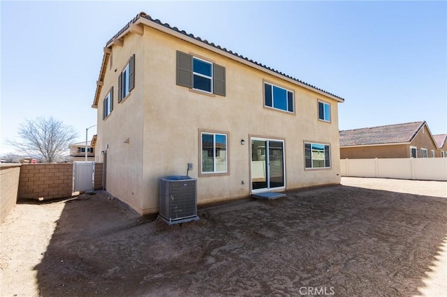 12990 Campbell Ct, Hesperia, CA 92344 - back of house featuring central air condition unit, a fenced backyard, a tiled roof, and stucco siding