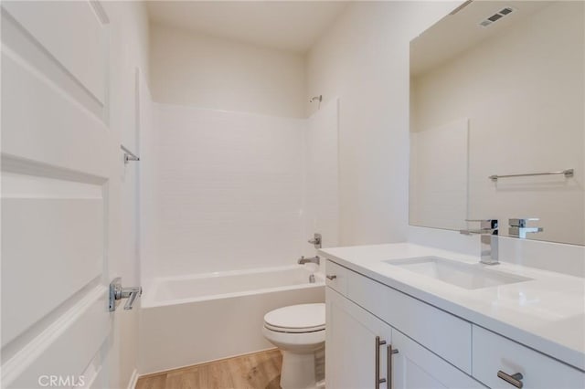 12990 Campbell Ct, Hesperia, CA 92344 - bathroom featuring toilet, wood finished floors, visible vents, vanity, and washtub / shower combination