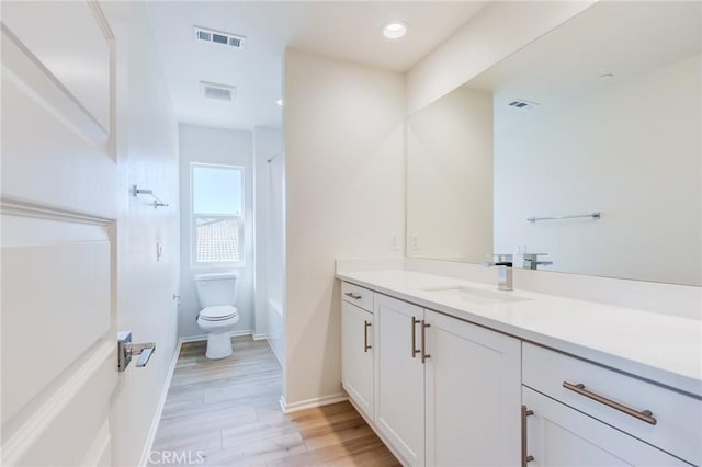 12990 Campbell Ct, Hesperia, CA 92344 - full bath featuring toilet, visible vents, wood finished floors, and vanity