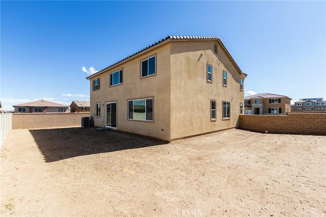 12990 Campbell Ct, Hesperia, CA 92344 - back of property with a fenced backyard, central AC, and stucco siding