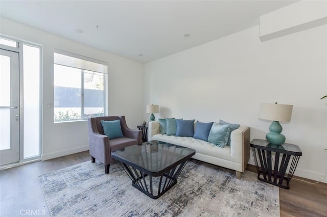 living area with wood finished floors and baseboards