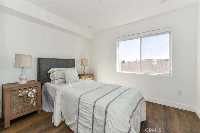 bedroom featuring baseboards and wood finished floors