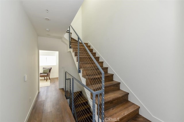 stairs featuring baseboards and wood finished floors