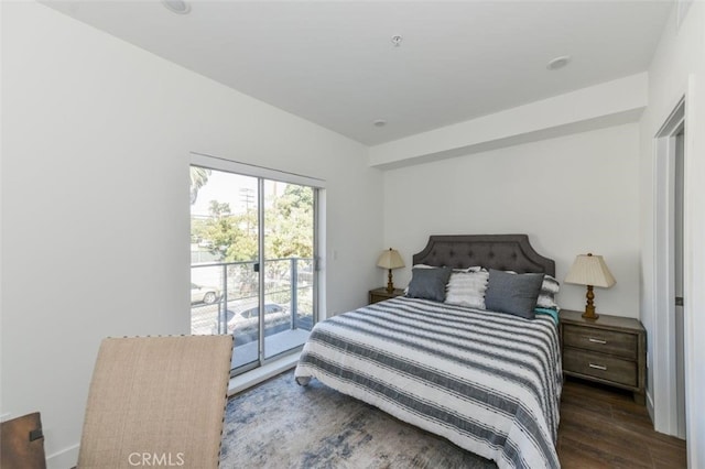 bedroom with access to outside and dark wood-type flooring