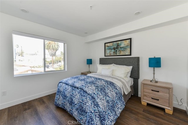 bedroom featuring dark wood-type flooring and baseboards