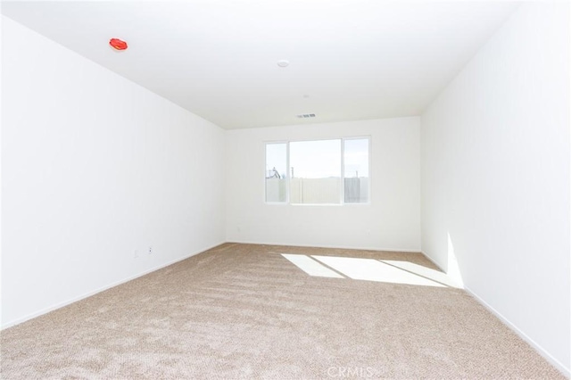 carpeted spare room with visible vents