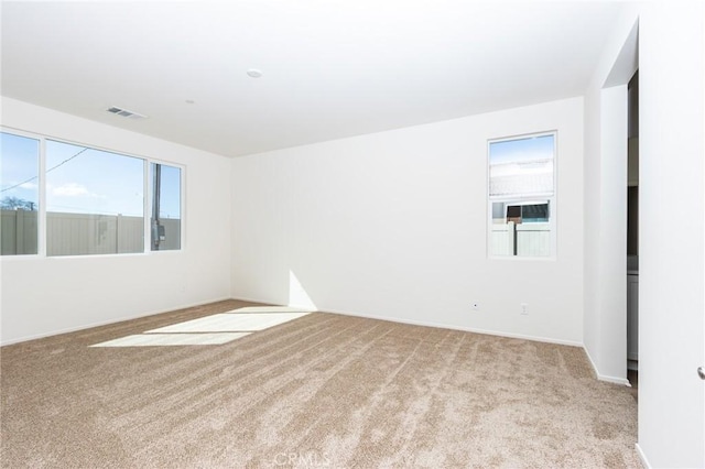 unfurnished room with visible vents and carpet flooring