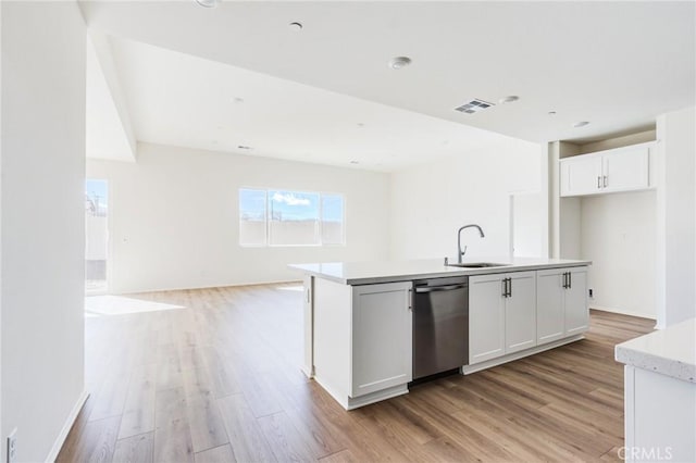 kitchen featuring open floor plan, visible vents, light wood-style flooring, and stainless steel dishwasher