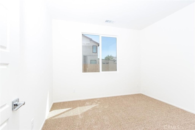 carpeted spare room with baseboards and visible vents