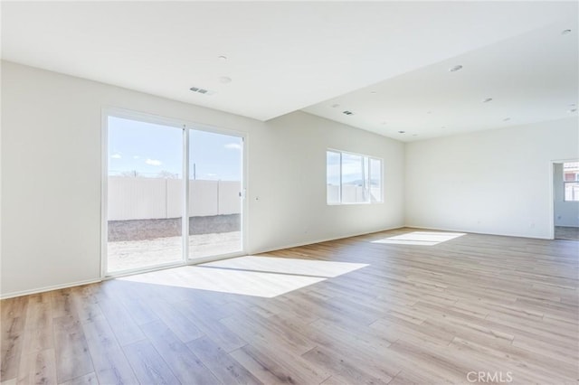 empty room featuring light wood finished floors and baseboards