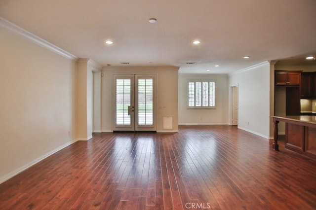 unfurnished living room with baseboards, dark wood finished floors, ornamental molding, french doors, and recessed lighting