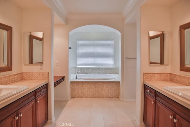 bathroom featuring a sink, ornamental molding, two vanities, and a garden tub