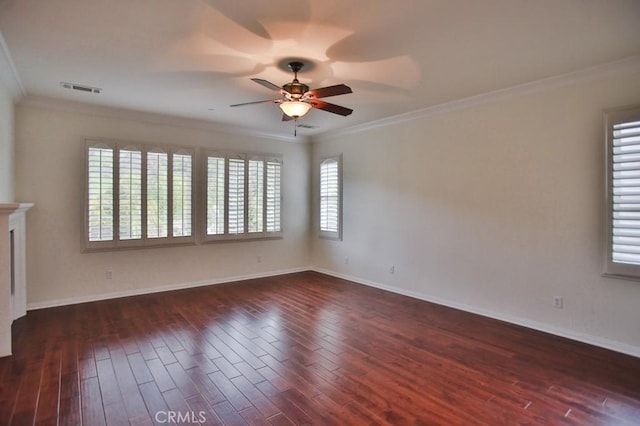 spare room featuring crown molding, a fireplace, visible vents, and dark wood-type flooring