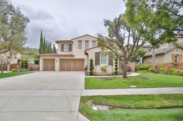 mediterranean / spanish house featuring driveway, stucco siding, a tile roof, and a front yard