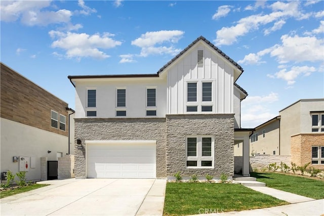 view of front of property with an attached garage, stone siding, board and batten siding, and concrete driveway