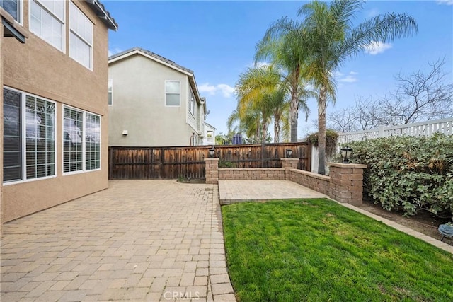 view of yard featuring a patio area and a fenced backyard