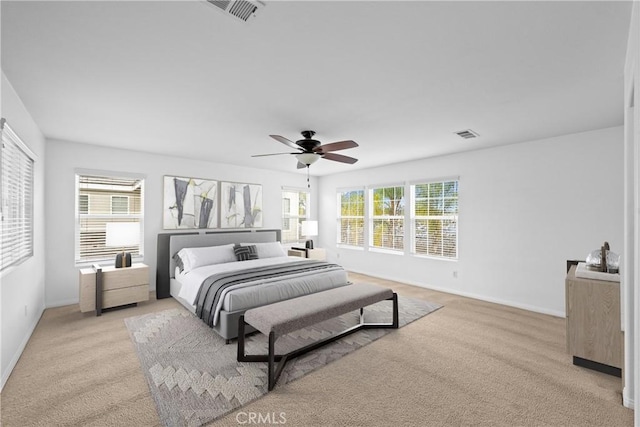 bedroom featuring light carpet, baseboards, and visible vents