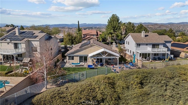 drone / aerial view featuring a residential view and a mountain view