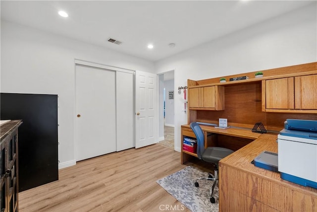 office space with light wood-type flooring, baseboards, visible vents, and recessed lighting