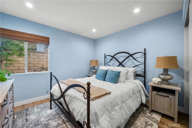 bedroom with light wood-type flooring, baseboards, and recessed lighting