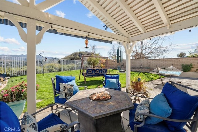 view of patio featuring an outdoor fire pit and a fenced backyard