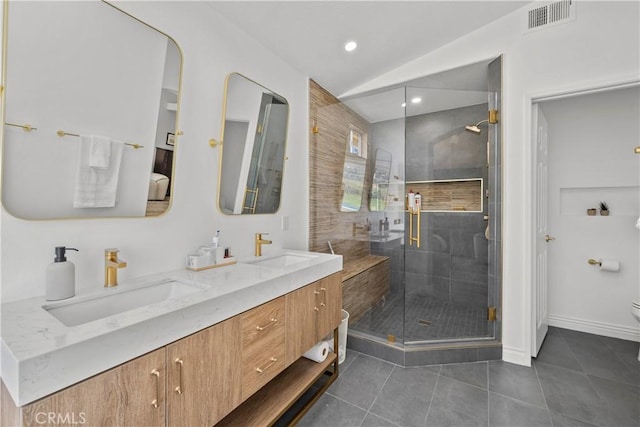 bathroom featuring toilet, a sink, visible vents, and tile patterned floors