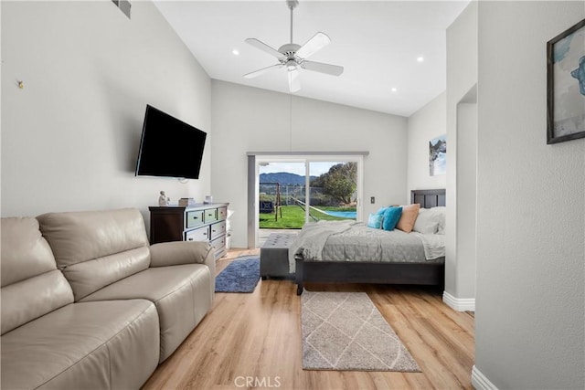 bedroom featuring baseboards, a ceiling fan, lofted ceiling, wood finished floors, and access to outside