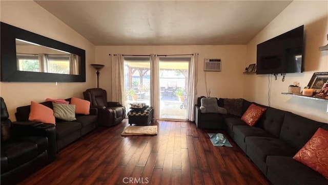 living room with wood-type flooring, vaulted ceiling, and a wall mounted air conditioner