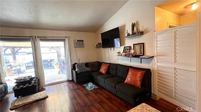 living area featuring lofted ceiling, a wall mounted AC, and wood finished floors