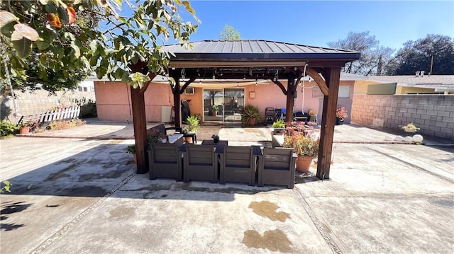 view of patio / terrace with fence and a gazebo