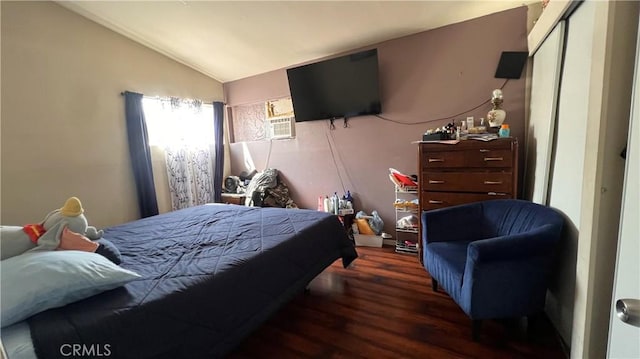 bedroom with vaulted ceiling and wood finished floors