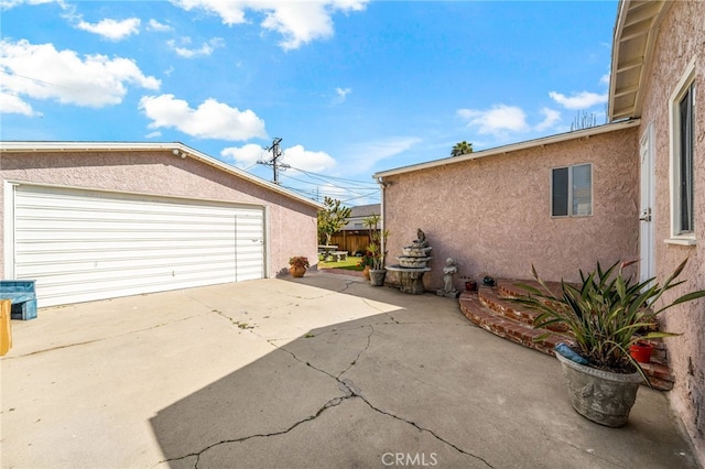 view of property exterior with a garage and stucco siding