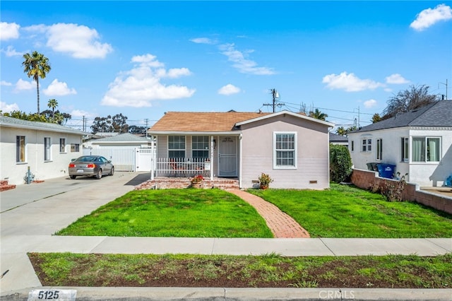 view of front of home with concrete driveway, crawl space, covered porch, fence, and a front yard