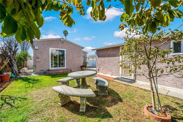 view of yard featuring an outdoor structure and fence