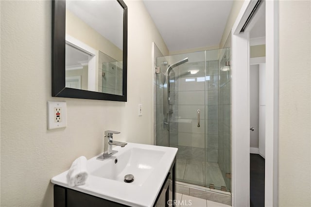 bathroom with a stall shower and vanity