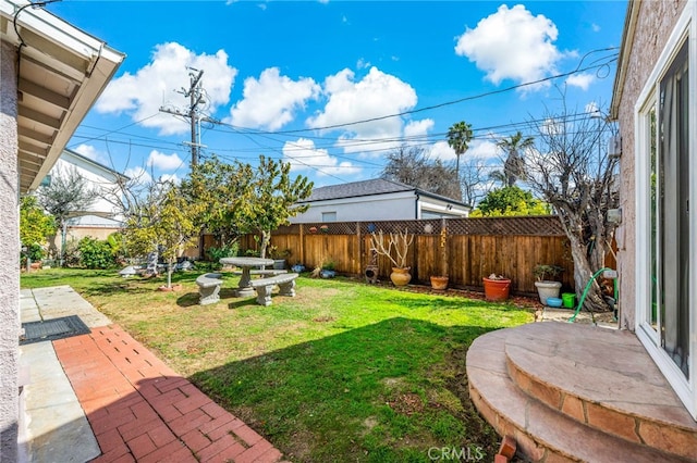 view of yard with a patio area and a fenced backyard