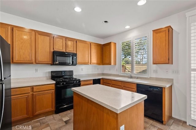 kitchen featuring a center island, light countertops, black appliances, a sink, and recessed lighting