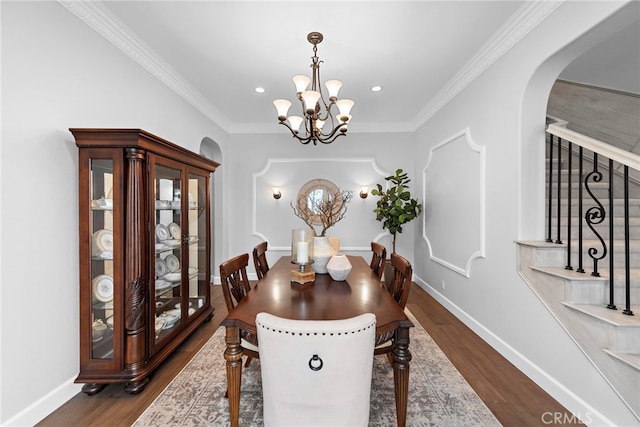 dining room featuring baseboards, a chandelier, stairway, dark wood-style floors, and arched walkways