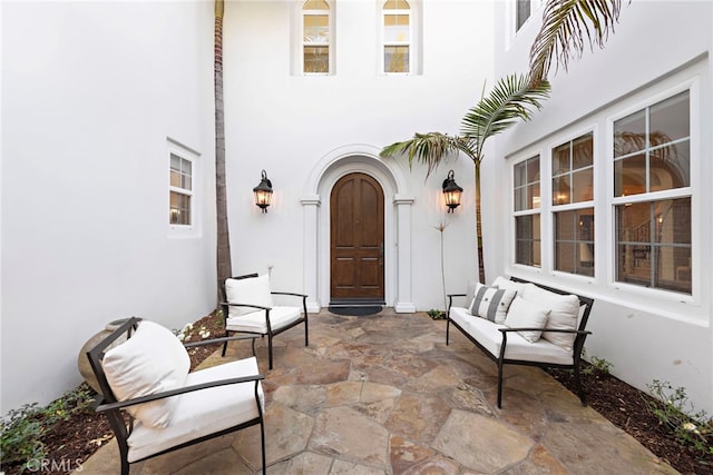 doorway to property with stucco siding and a patio