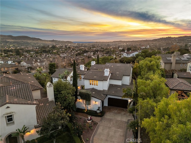 aerial view at dusk featuring a residential view