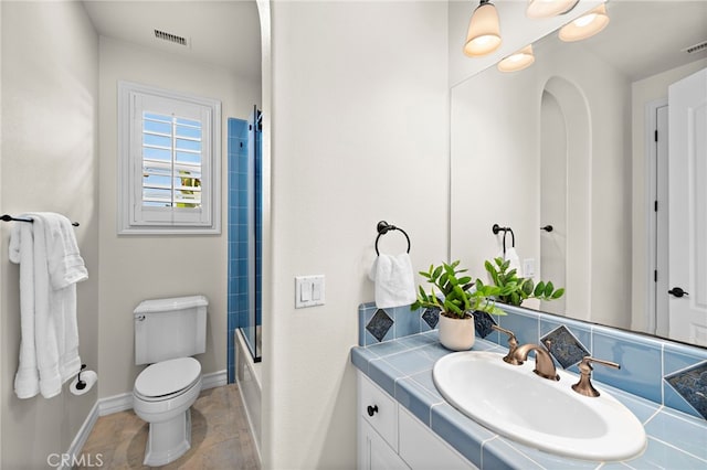 bathroom featuring visible vents, baseboards, toilet, and vanity