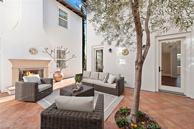 view of patio featuring an outdoor living space with a fireplace