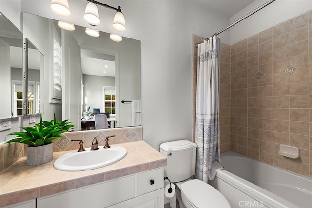 bathroom featuring vanity, toilet, and shower / tub combo with curtain