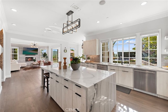 kitchen with a glass covered fireplace, visible vents, a sink, dishwasher, and modern cabinets