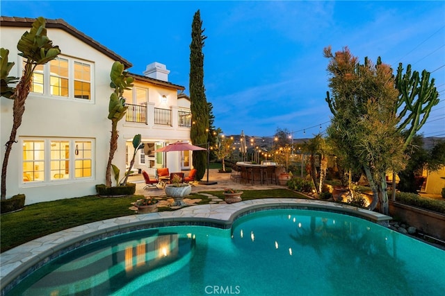 pool featuring outdoor dry bar and a patio