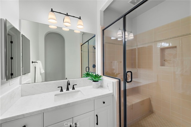 full bath featuring visible vents, a stall shower, and vanity